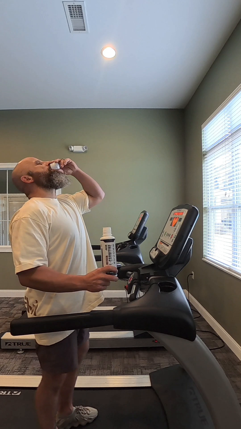 Taking a capful of JCKED Liquid L-Carnitine before a session